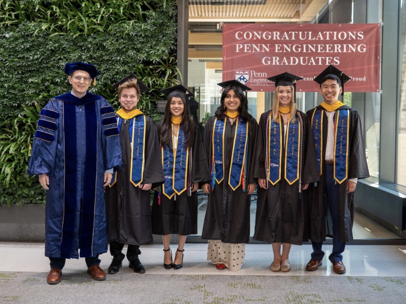 George J. Pappas in academic regalia with five graduates of the B.S.E. in Artificial Intelligence, Class of 2026, at Penn Engineering