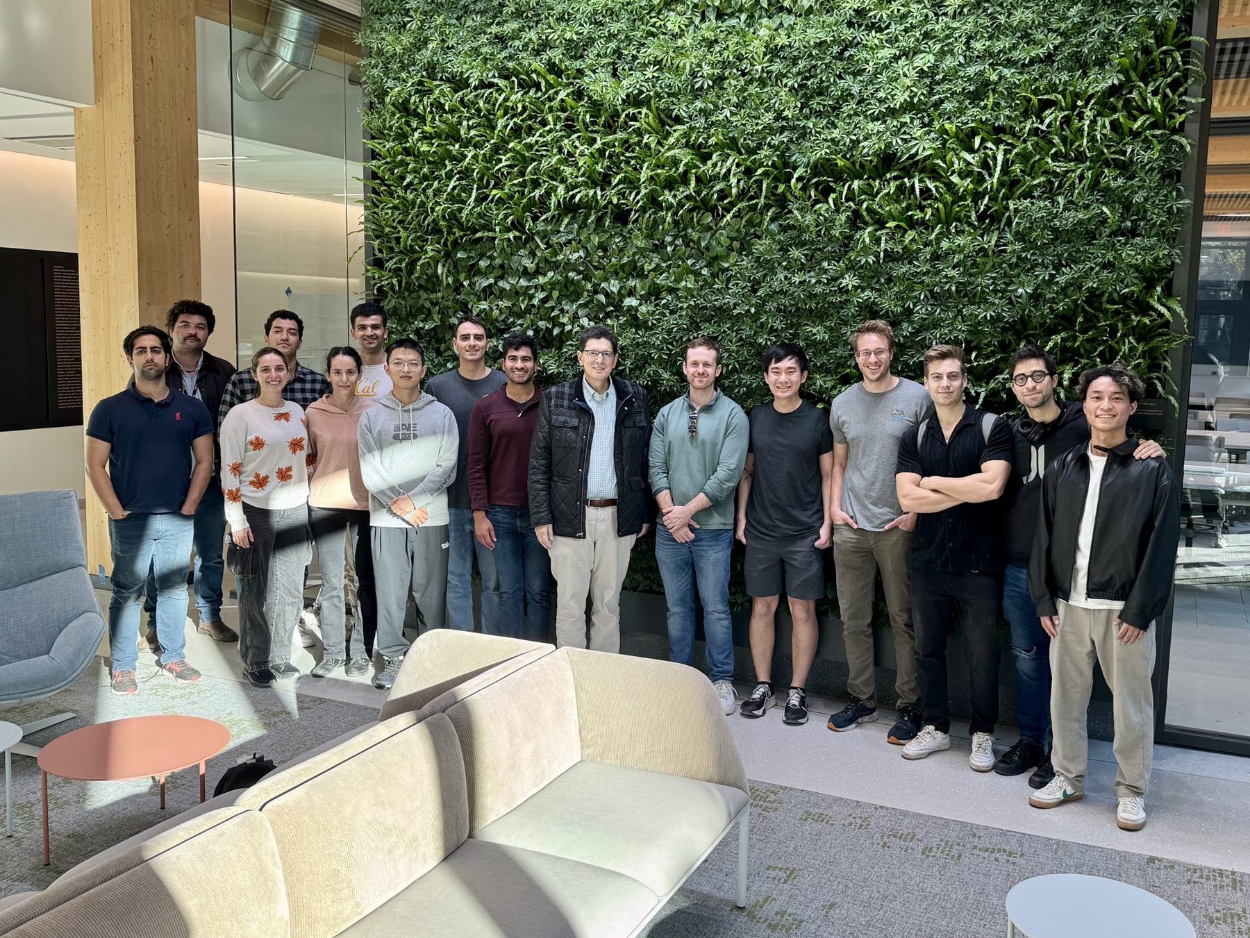Current members of the Pappas research group with George J. Pappas in front of a living plant wall at Penn